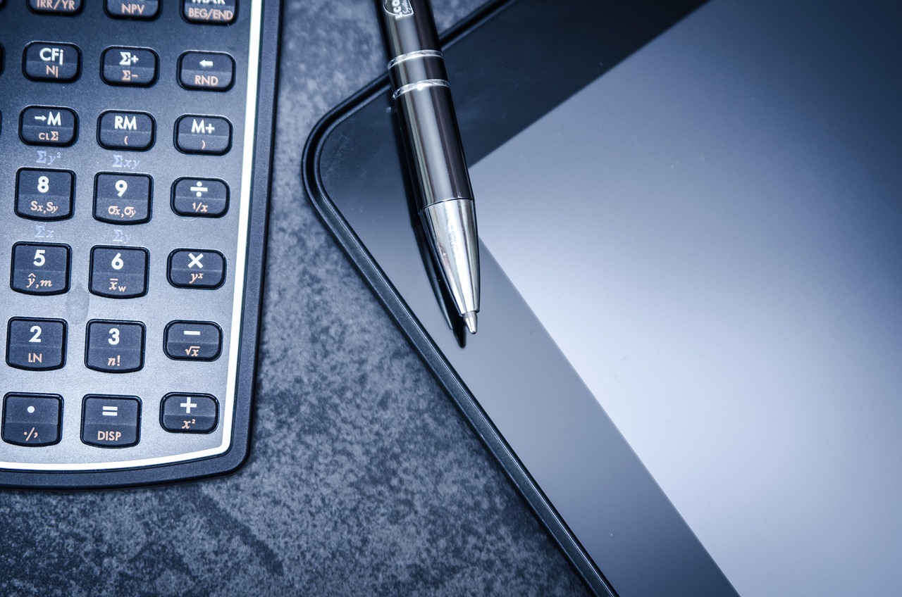 Tablet, calculator, business — Investing Using the Top-to-Bottom Approach